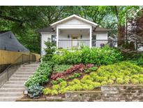 Charming craftsman home featuring a landscaped front yard, a welcoming porch, and a bright yellow front door at 571 Morgan Ne St, Atlanta, GA 30308