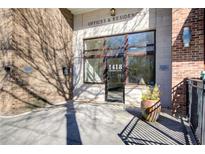 Building entrance with brick and stone exterior, featuring large windows and signage for offices and residences at 1418 Dresden Ne Dr # 385, Brookhaven, GA 30319