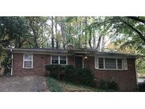 Charming brick home featuring a traditional design and mature trees in a serene setting at 2226 Medfield Ne Trl, Atlanta, GA 30345