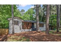 Charming renovated home with painted brick, wood accent wall, and professional landscaping at 2238 Pinecliff Ne Dr, Atlanta, GA 30345