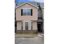 Charming townhome featuring a neutral facade, black shutters, a gray roof, and an inviting front entrance at 7314 Bridlewood Ct, Jonesboro, GA 30236
