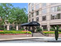 Elegant building entrance with manicured landscaping and a covered entryway, enhancing the property's curb appeal at 3475 Oak Valley Rd # 1850, Atlanta, GA 30326