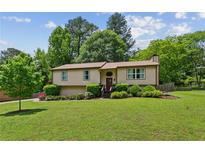 Charming single-Gathering home with a well-manicured lawn, mature trees, and tasteful landscaping at 4192 Alaina Cir, Austell, GA 30106