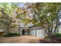 Charming two-story home featuring a stone chimney, inviting entryway, and two-car garage at 626 Kimberly Ne Ln, Atlanta, GA 30306