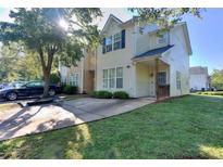 Charming two-story townhome featuring a well-maintained lawn and ample parking space at 2326 Nicole Dr, Hampton, GA 30228