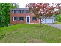Charming two-story brick home with a well-manicured lawn and a two car garage at 1492 Harbins Rd, Norcross, GA 30093