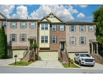 Attractive brick townhome with well-maintained landscaping, garage, and a welcoming entrance at 3692 Lambert Ne Ln, Brookhaven, GA 30319