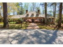 Beautiful brick home with a charming brick walkway and well-manicured lawn at 9995 Huntcliff Trce, Atlanta, GA 30350