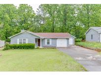 Charming one-story home with well-maintained lawn, attached garage, and mature trees at 376 Paula Ct, Lawrenceville, GA 30046