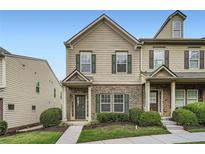 Charming two-story townhome with brick accents, green shutters, and well-manicured landscaping at 3807 Cyrus Ridge Nw Way, Kennesaw, GA 30152
