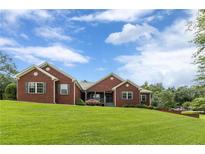 Inviting brick home with a well-manicured lawn and charming curb appeal at 516 Main St, Hiram, GA 30141