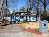 Charming one-story home with a manicured lawn and a brick mailbox at 551 Floyd Se Dr, Smyrna, GA 30082