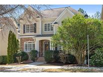 Charming two-story home featuring a stone facade, manicured landscaping, and classic architectural details at 1967 Mason Mill Rd, Decatur, GA 30033