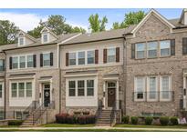 Charming townhome exterior featuring brick facade, shuttered windows, and welcoming front entrance at 1188 Parktown Dr, Mableton, GA 30126
