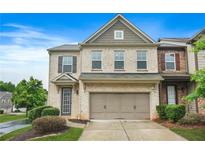 Charming two-story townhome with a brick facade and a convenient attached two-car garage at 5830 Keystone Pt, Lithonia, GA 30058