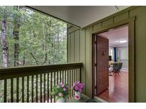 Inviting entryway with a wooded view from the porch and access to an office space with hardwood floors at 1015 Dunbar Dr, Dunwoody, GA 30338