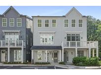 Charming, light blue, two-story townhome with a balcony and beautifully landscaped front yard at 3 Becker Nw Pl, Atlanta, GA 30307