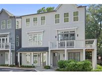 Charming three-story townhome with balcony and neutral gray paint at 3 Becker Nw Pl, Atlanta, GA 30307