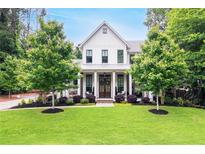 Charming, two-story traditional home with a manicured lawn and a welcoming front porch at 201 Dobbs Rd, Woodstock, GA 30188