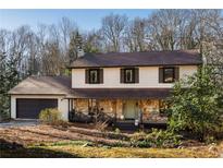 Charming two-story home boasts stone accents, a cozy front porch, and an attached garage at 4568 Oswood Ct, Tucker, GA 30084