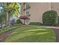 Attractive building entrance with manicured lawn and a stylish canopy at 395 Pharr Ne Rd # 103, Atlanta, GA 30305