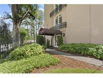 Beautiful building entrance with lush landscaping and covered entryway, showcasing the inviting curb appeal at 395 Pharr Ne Rd # 103, Atlanta, GA 30305