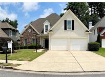 Charming two-story home with a stone facade, manicured lawn, and a two-car garage at 1294 Parkview Nw Ln, Kennesaw, GA 30152