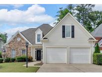 Charming two-story home with stone accents, manicured lawn, and a two-car garage at 1294 Parkview Nw Ln, Kennesaw, GA 30152