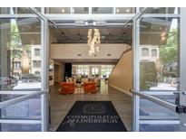 A grand lobby with high ceilings, a modern chandelier, and a cozy seating area creates a welcoming atmosphere at 711 Cosmopolitan Ne Dr # 338, Atlanta, GA 30324
