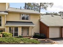 Charming townhome with attached garage and well-maintained landscaping at 6806 Glenridge Dr # E, Atlanta, GA 30328