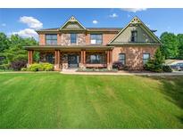 Beautiful brick home with a large front yard and welcoming porch at 501 Rabun Ct, Canton, GA 30115