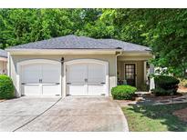 Charming home with a two-car garage and well-maintained landscaping at 4068 Cottage Oaks Dr, Acworth, GA 30101