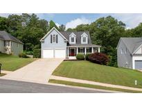 Charming two-story home with a well-manicured lawn, two car garage and inviting front porch at 118 Valleyside S Dr, Dallas, GA 30157