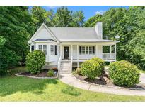 Charming home with a manicured lawn, covered porch and mature landscaping at 1595 Cedar Hl, Douglasville, GA 30134