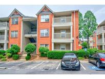 Charming brick condo building with well-maintained landscaping and assigned parking at 4106 Chastain Park Ne Ct, Atlanta, GA 30342