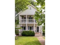 Charming two-story home featuring double front porches with white railings and classic architectural details at 207 Wesley Ne Ave, Atlanta, GA 30307