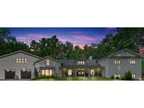 Stunning exterior elevation of home at dusk with meticulous landscaping and charming front porch at 1421 Hendon Rd, Woodstock, GA 30188