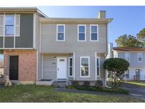 Charming two-story home with light grey siding, white trim, and a well-manicured front yard at 107 Woodberry Ct, Woodstock, GA 30188