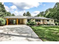 Charming single-story home featuring a covered carport, brick facade, and well-maintained landscaping at 2568 Laurelwood Rd, Atlanta, GA 30360