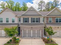 Charming two-story townhome with a brick-accented facade and a two-car garage in a desirable neighborhood at 6780 Cedar Glen Rd, Peachtree Corners, GA 30360