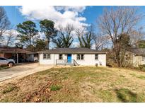 Charming single-story home features a bright blue front door, painted brick, and a well-maintained front yard at 3224 Canary Ct, Decatur, GA 30032