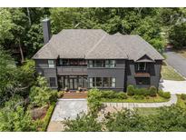 Stately two-story home with a manicured front yard and gray exterior, surrounded by mature trees at 320 Shady Grove Ln, Alpharetta, GA 30009