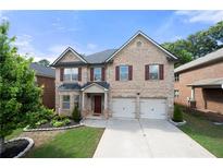 Charming two-story brick home featuring a well-maintained yard and two-car garage at 1181 Gateview Dr, Lawrenceville, GA 30046