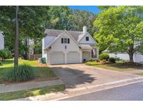 Charming two-story home with a two-car garage and well-maintained landscaping at 141 Weatherstone Dr, Woodstock, GA 30188