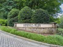 Stone entrance sign to Vinings Run community surrounded by manicured landscaping and mature trees at 2610 Cumberland Ct, Smyrna, GA 30080