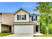 Charming two-story home featuring a two-car garage and a well-maintained front yard with attractive landscaping at 7630 Volion Pkwy, Fairburn, GA 30213