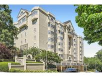 Elegant multi-story condominium building with manicured landscaping and a secure gated entrance at 2499 Peachtree Ne Rd # 108, Atlanta, GA 30305