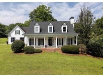 Charming single-Gathering home featuring a large front porch and manicured lawn at 255 Henson Way, Canton, GA 30115