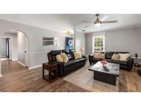 Comfortable living room features wood floors, ceiling fan and leather sofas for a relaxing space at 1140 Moorestown Cir, Decatur, GA 30033