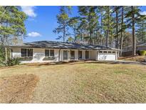 Charming single-story home featuring a well-maintained lawn and a classic brick facade, perfect for suburban living at 4178 Castle Pines Ct, Tucker, GA 30084